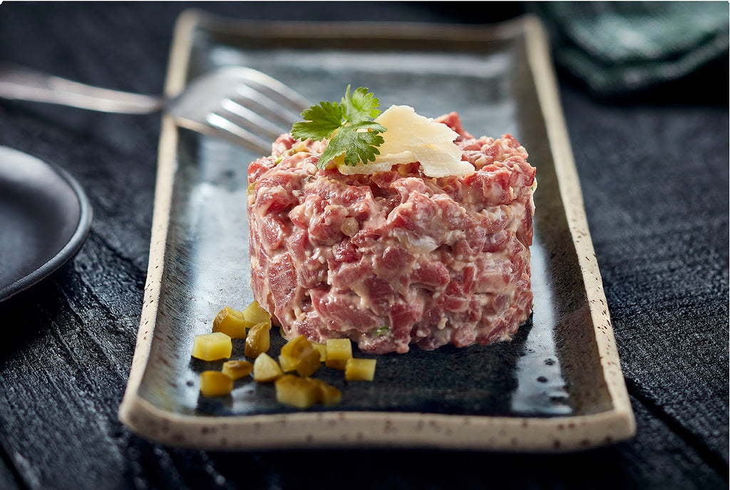 Beef tartar with parmesan cheese and dill pickle